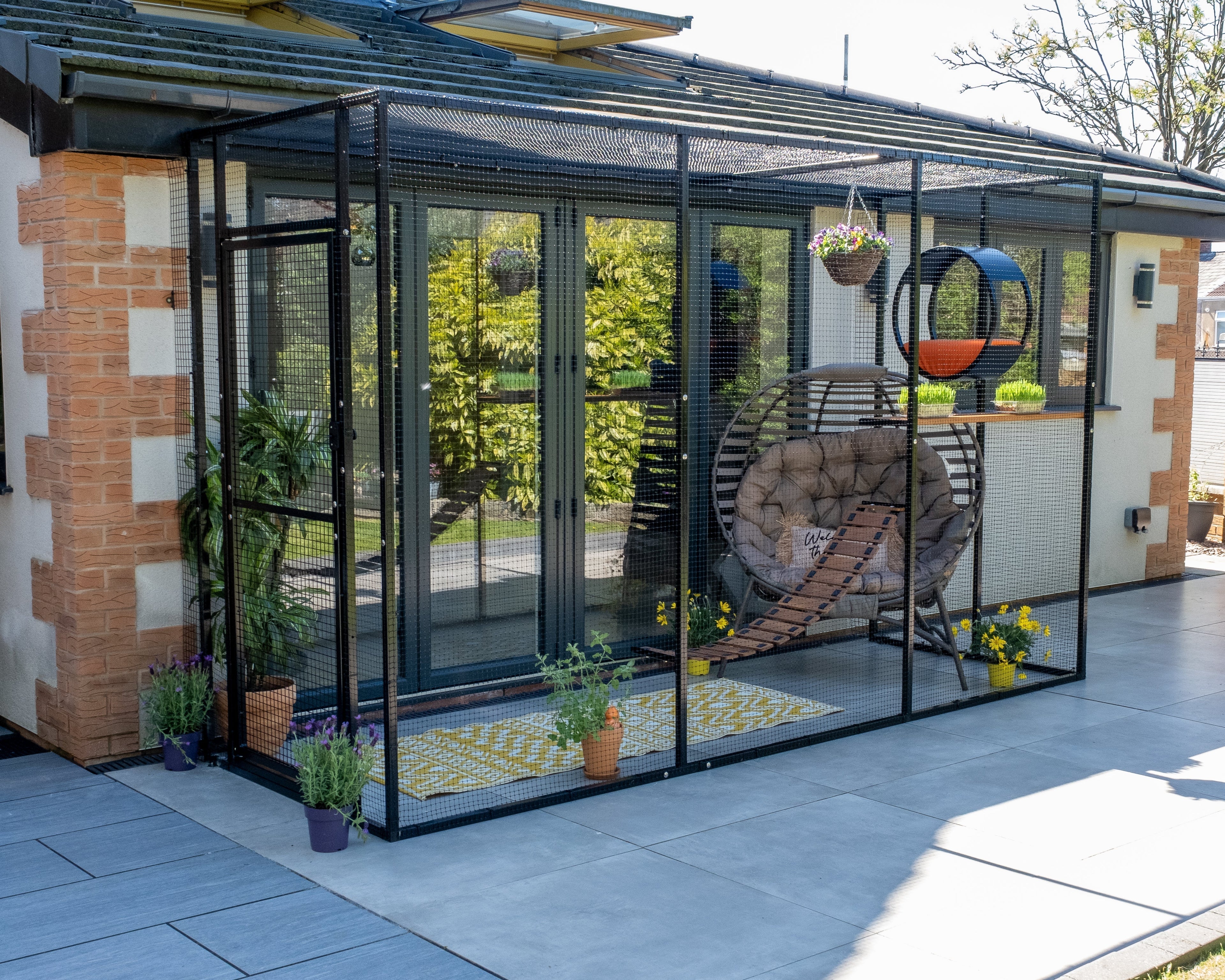 Spacious outdoor ProtectaPet Catio connected to a home, creating a safe and enriching environment for cats to enjoy fresh air and outdoor access.